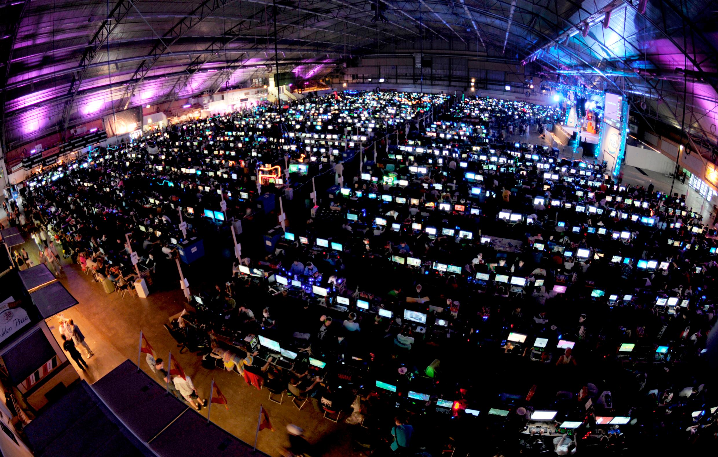 A huge arena filled with lit up computer screens.