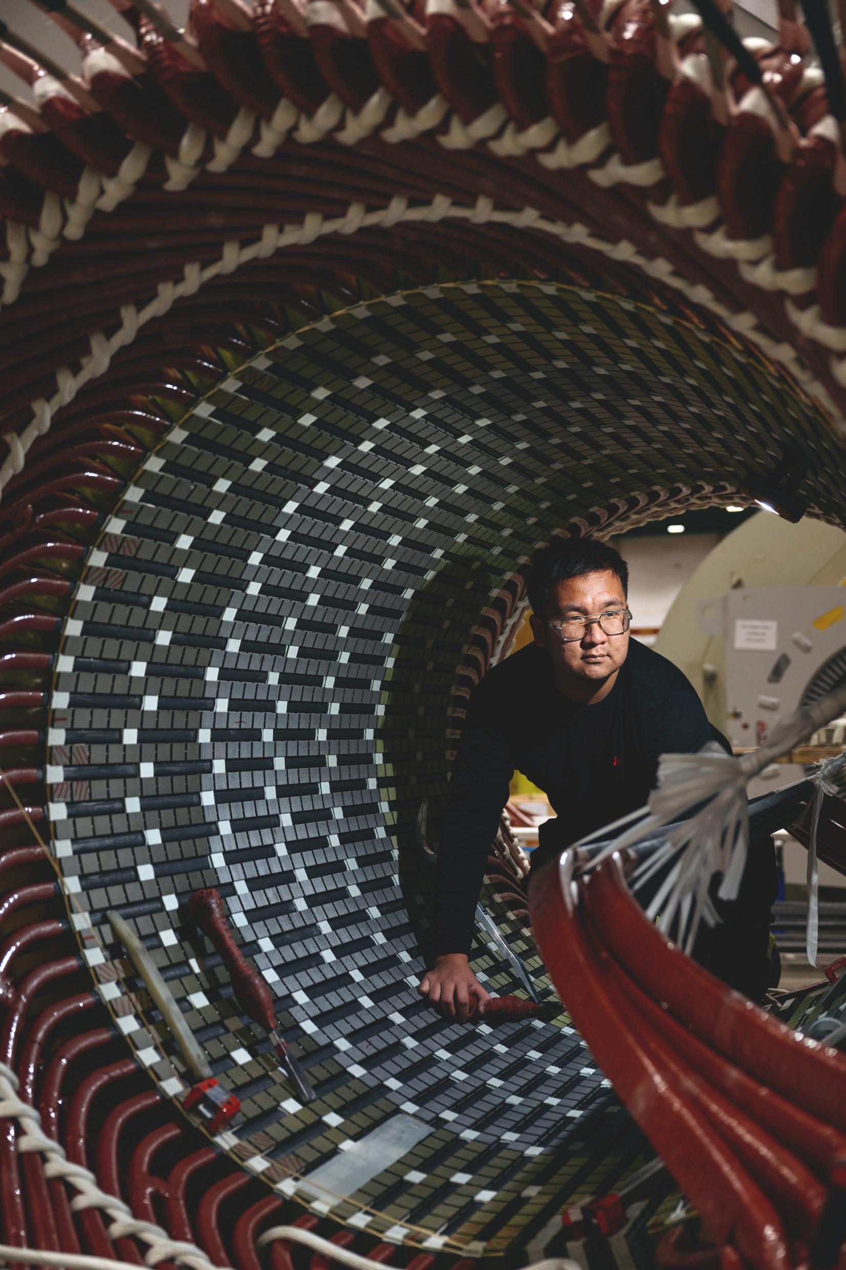 A worker inside a large drum.