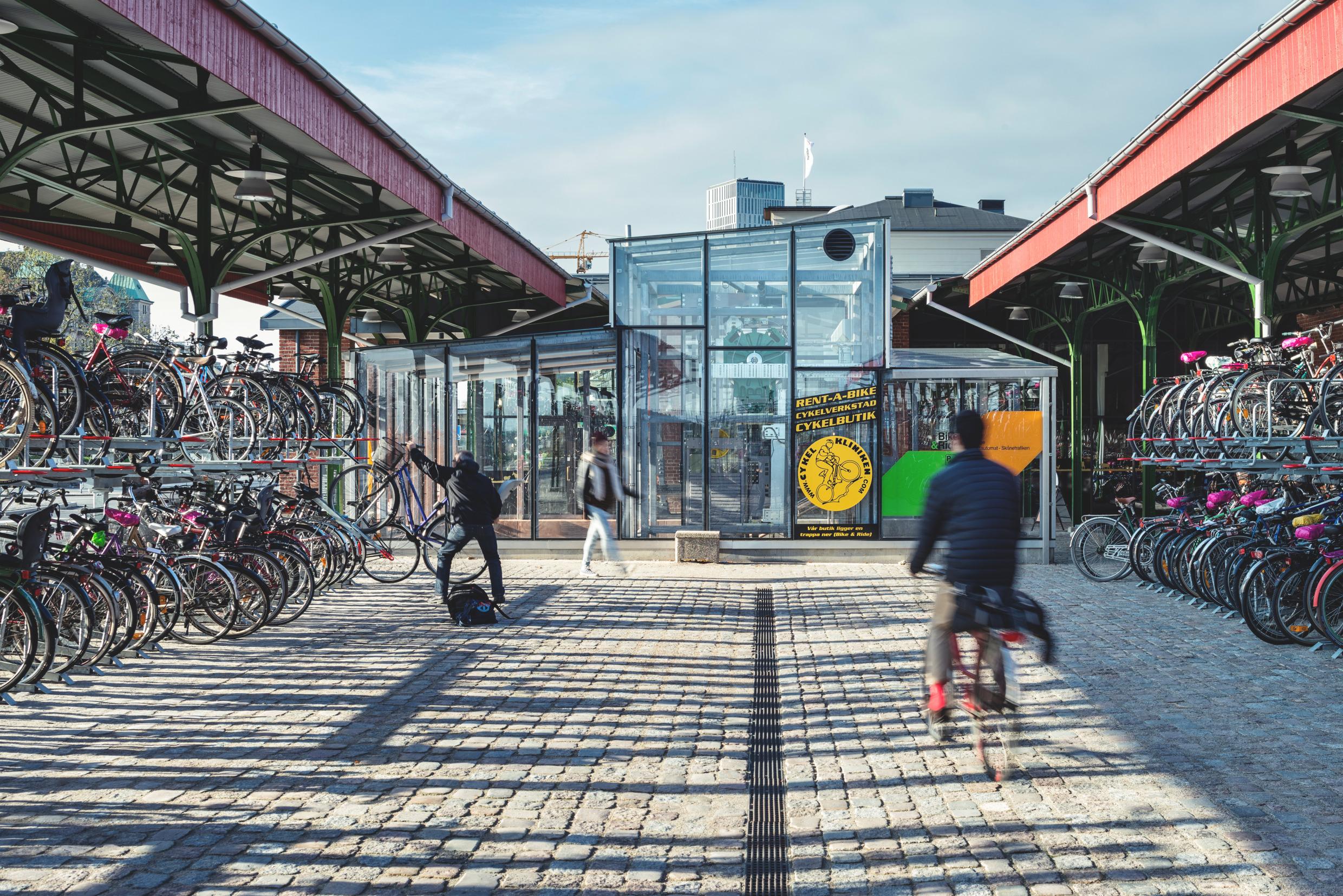 People cycling and walking through an urban area in Sweden.